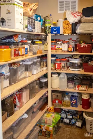 a view of a storage area with stainless steel appliances