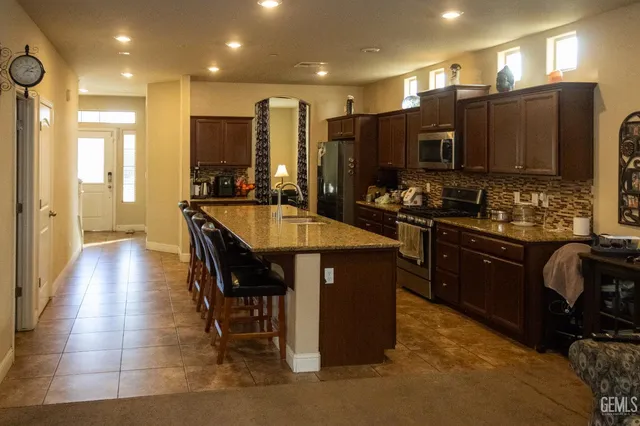 a large kitchen with a table and chairs