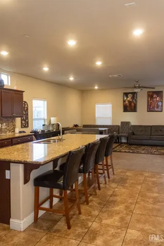 a view of kitchen with sink dining table and chairs