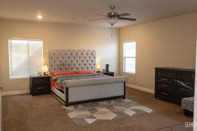 a living room with a bed and a dresser