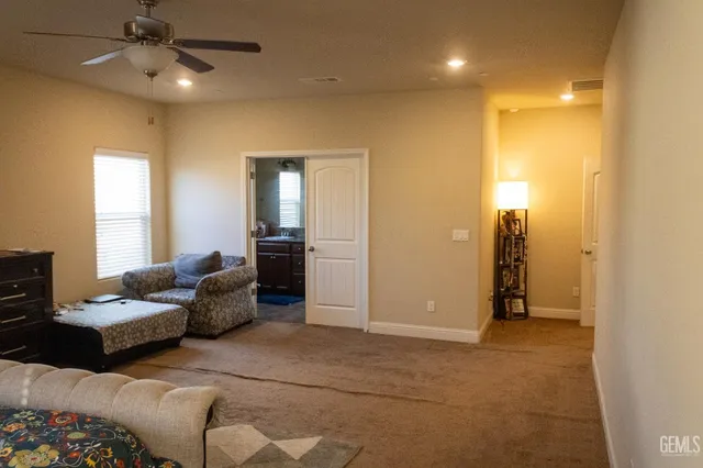 a living room with furniture and a ceiling fan