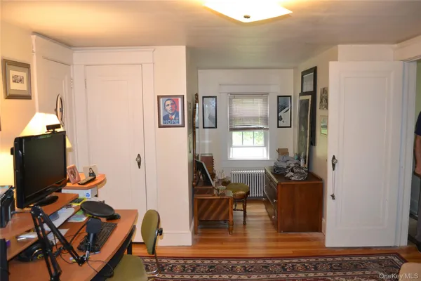 a living room with furniture a piano and a window