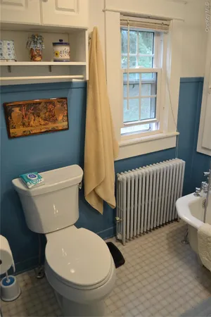 a white toilet sitting next to a bathroom sink