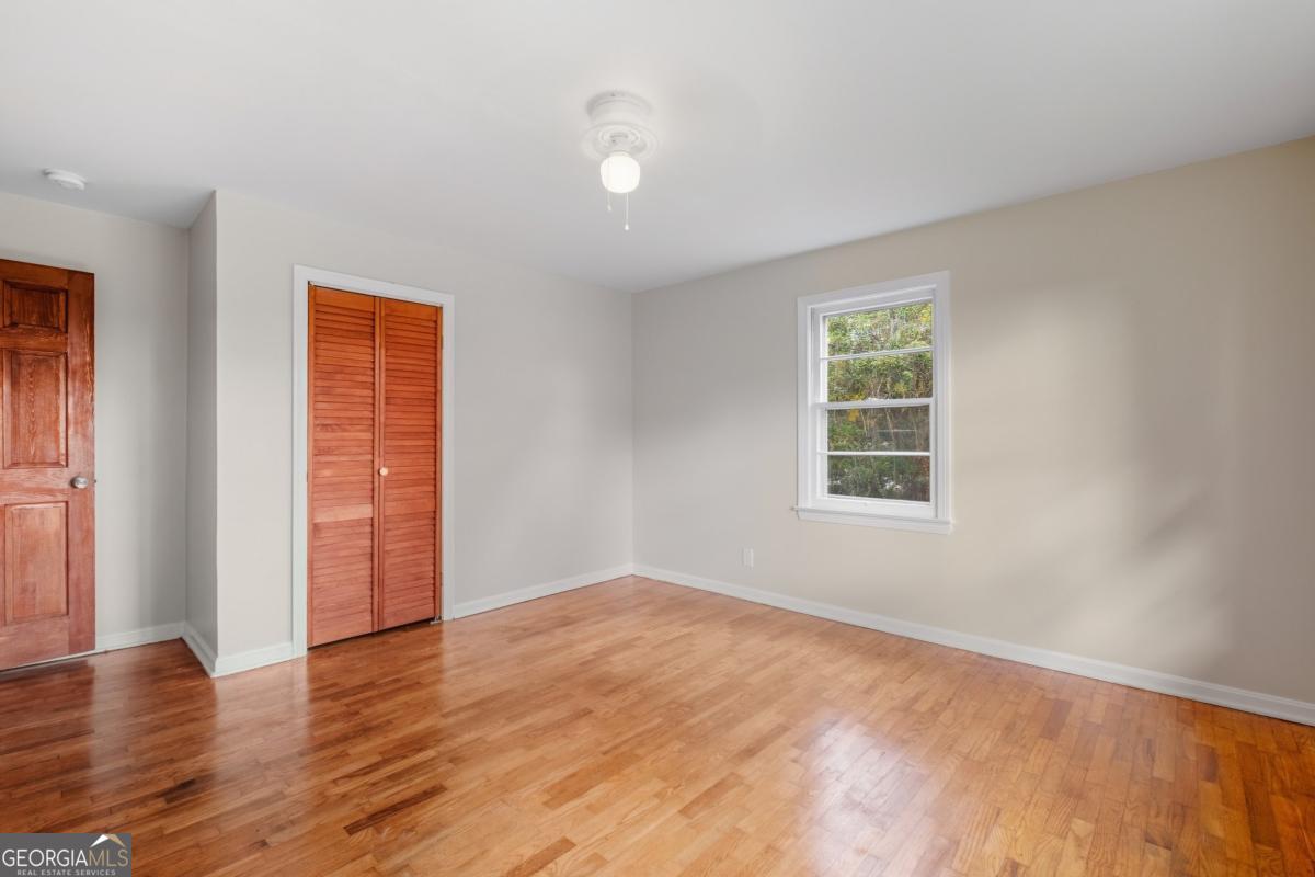 14 Mitchell Circle Rome, GA 30161 - Photo 13 of 39 an empty room with wooden floor and windows