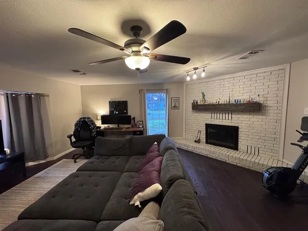 a living room with furniture and a fireplace