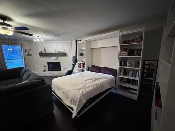 a bedroom with a bed and a fireplace
