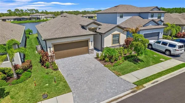 an aerial view of a house with a yard and potted plants
