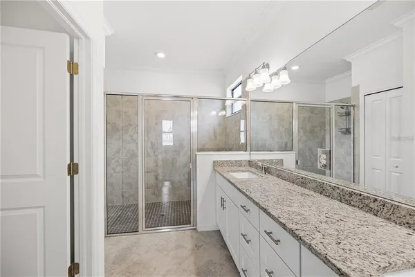a bathroom with a granite countertop sink a toilet and bathtub