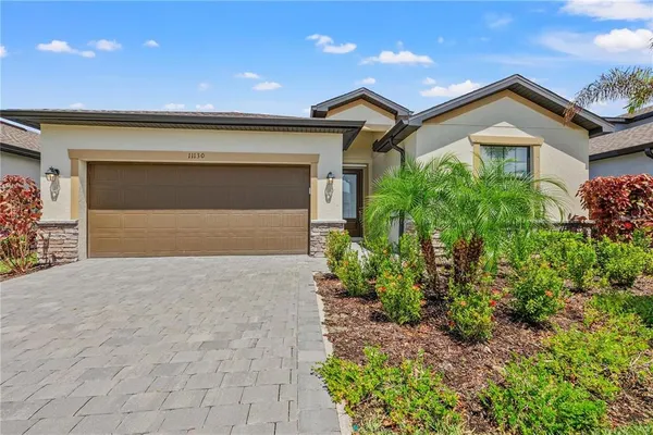 a front view of a house with a yard and garage