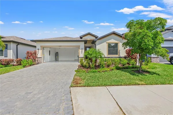 a front view of a house with a yard and a garage