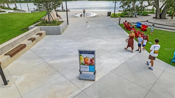 an aerial view of residential houses with outdoor space and trees