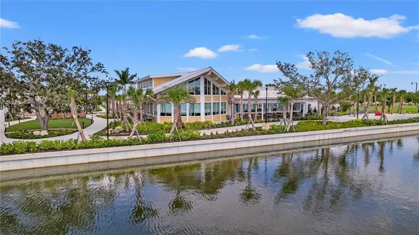 an aerial view of a house with outdoor space and lake view