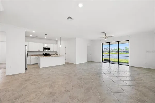 a view of kitchen with refrigerator and window