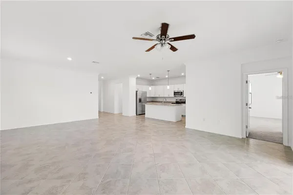 a view of a kitchen with a sink and stainless steel appliances