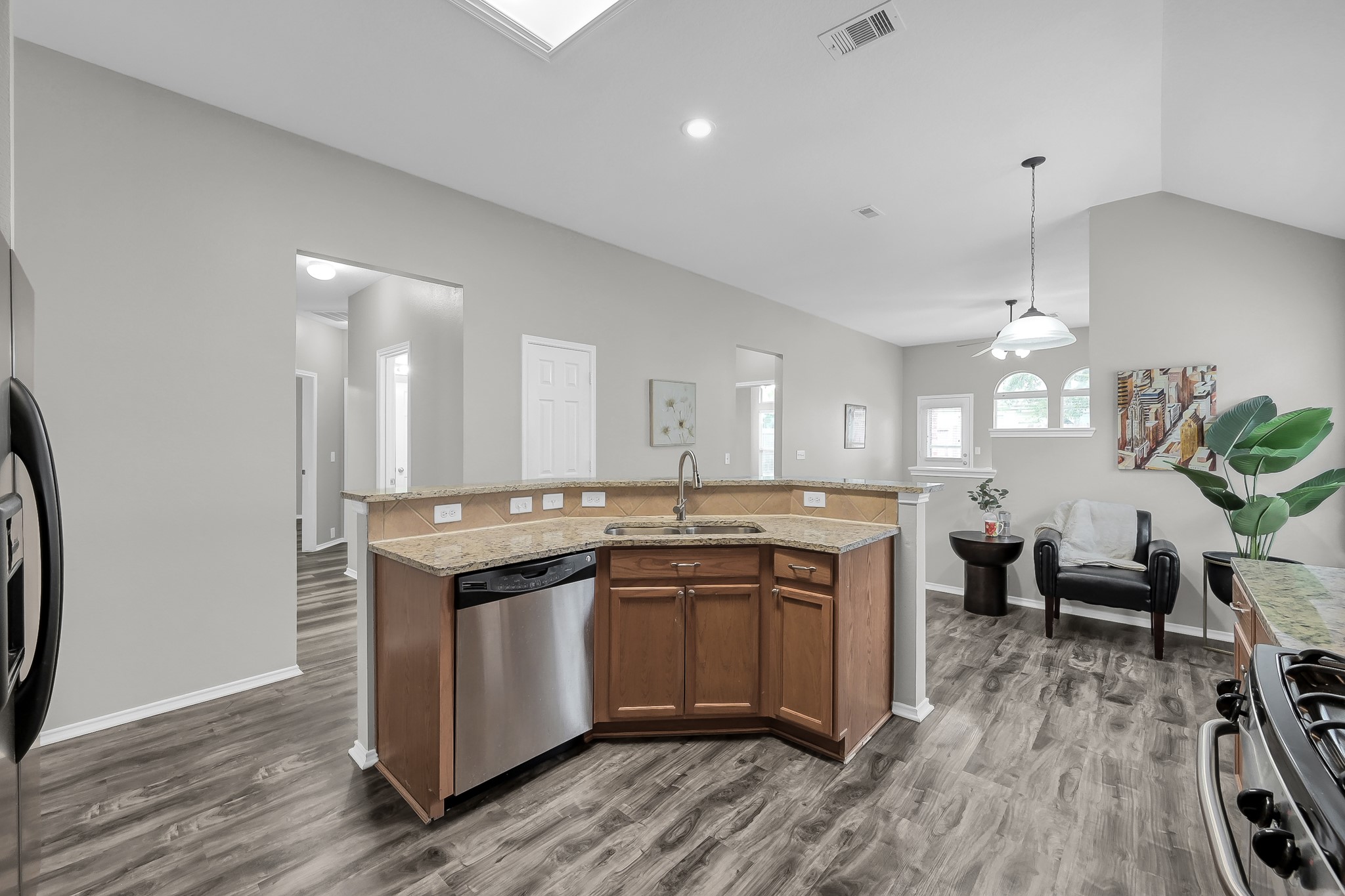 30206 Mesa Valley Drive Spring, TX 77386 - Photo 11 of 38 a kitchen with stainless steel appliances granite countertop a sink a stove and a wooden floors