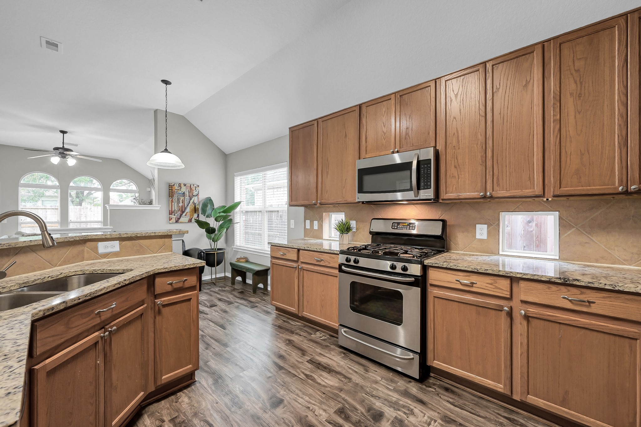 30206 Mesa Valley Drive Spring, TX 77386 - Photo 12 of 38 a kitchen with granite countertop wooden cabinets and a stainless steel appliances