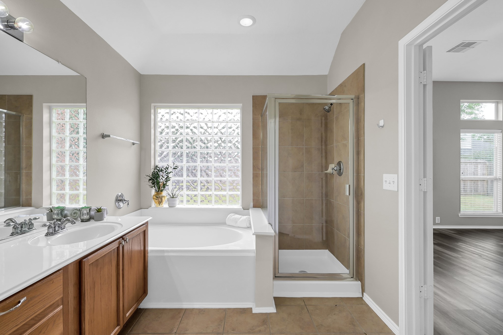 30206 Mesa Valley Drive Spring, TX 77386 - Photo 21 of 38 a bathroom with a tub sink shower and two mirror
