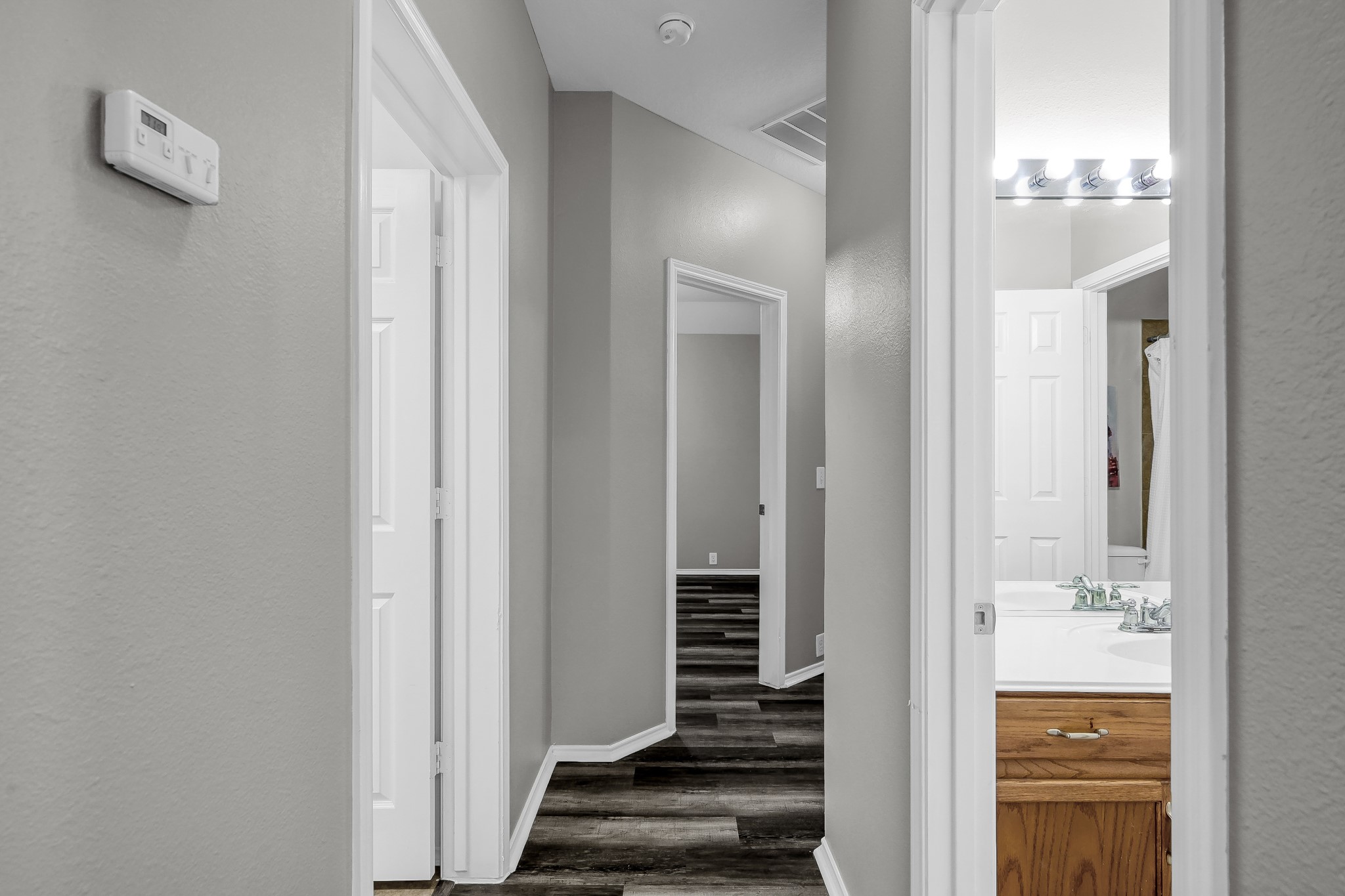 30206 Mesa Valley Drive Spring, TX 77386 - Photo 23 of 38 a view of a hallway with wooden floor and staircase