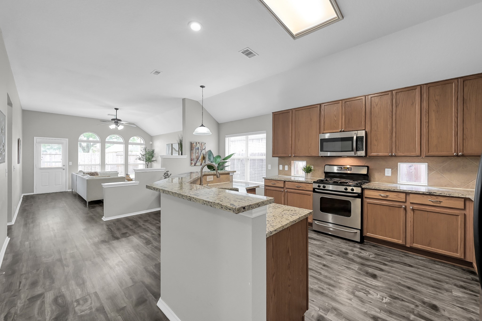 30206 Mesa Valley Drive Spring, TX 77386 - Photo 10 of 38 a kitchen with stainless steel appliances granite countertop a sink stove refrigerator and cabinets