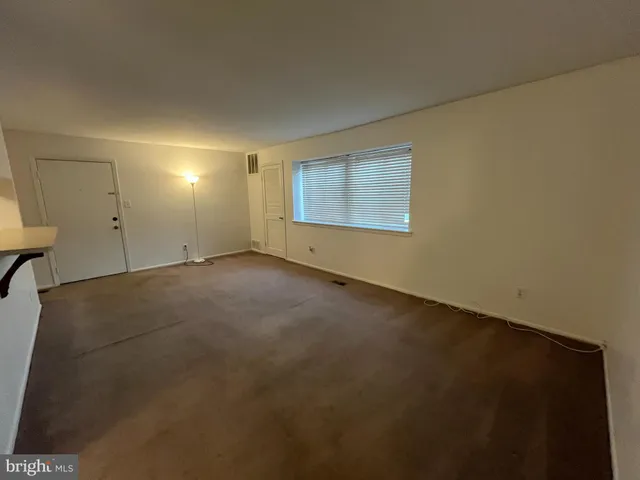 an empty room with a empty space and windows