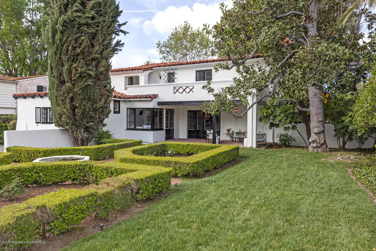626 Chaucer Road San Marino, CA 91108 - Photo 27 of 31 a front view of a house with a yard table and chairs