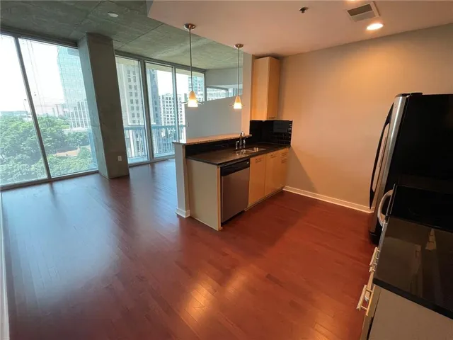 a kitchen with stainless steel appliances granite countertop a refrigerator and a stove
