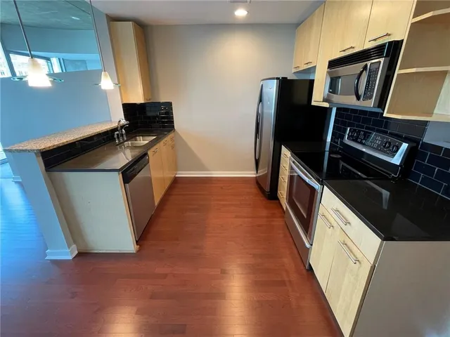 a view of a living room with a kitchen