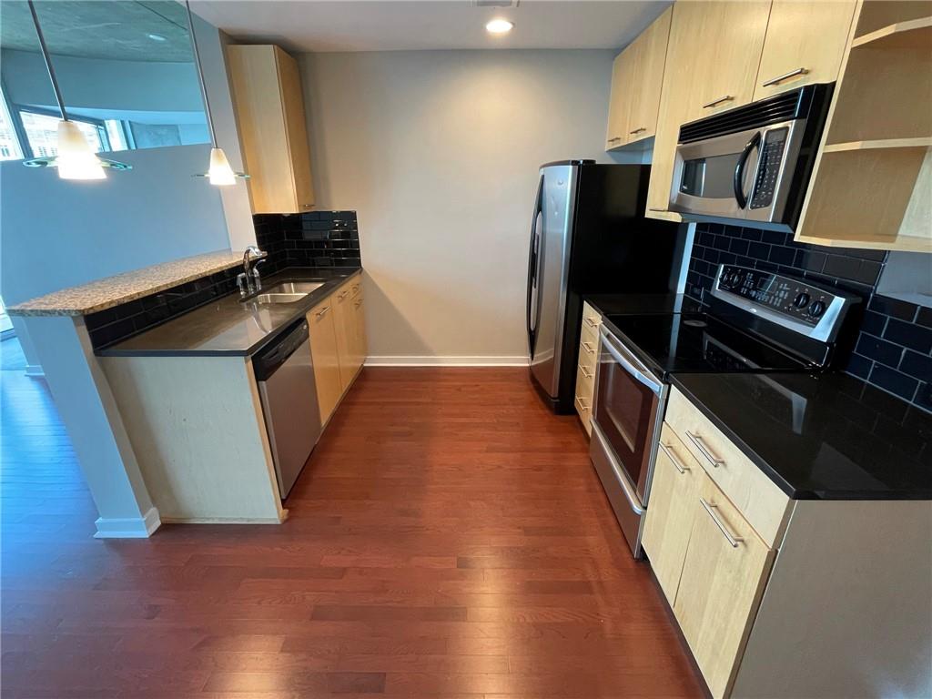 3324 Peachtree Road Northeast, Unit 908 Atlanta, GA 30326 - Photo 4 of 46 a kitchen with stainless steel appliances granite countertop a refrigerator and a stove