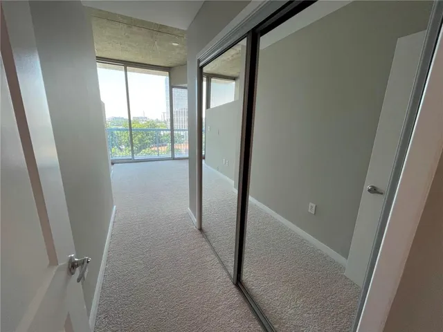 a view of an empty room with a large window