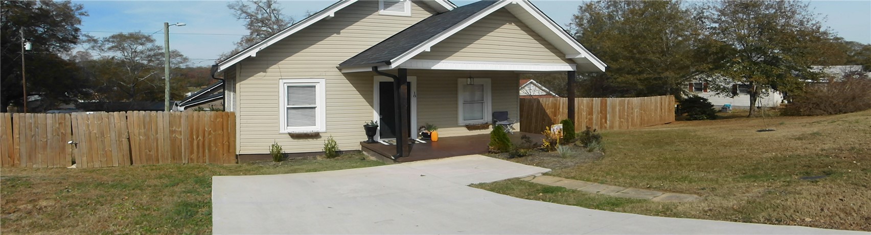 This charming home offers a welcoming facade and a fenced yard for privacy.