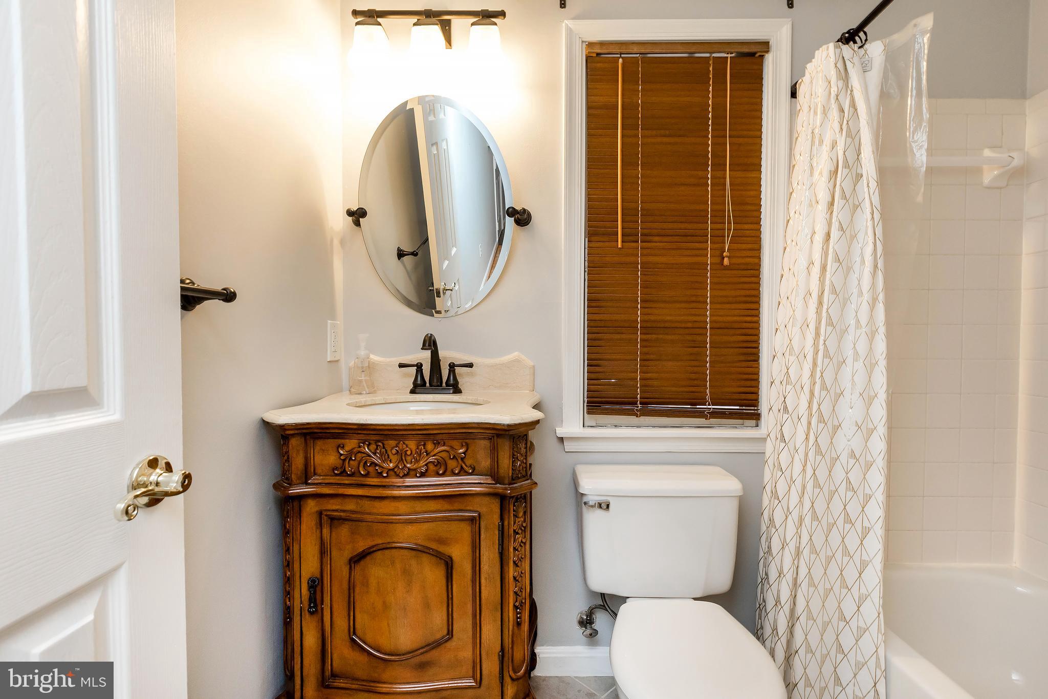 205 Ridgepoint Place Gaithersburg, MD 20878 - Photo 12 of 51 a bathroom with a toilet a sink and a mirror