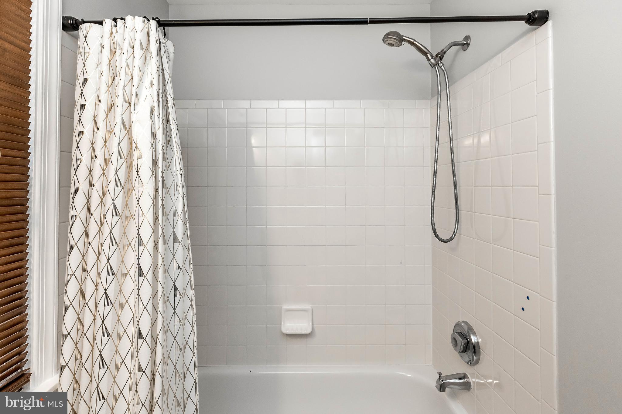 205 Ridgepoint Place Gaithersburg, MD 20878 - Photo 13 of 51 a bathroom with a shower curtain and a shower curtain