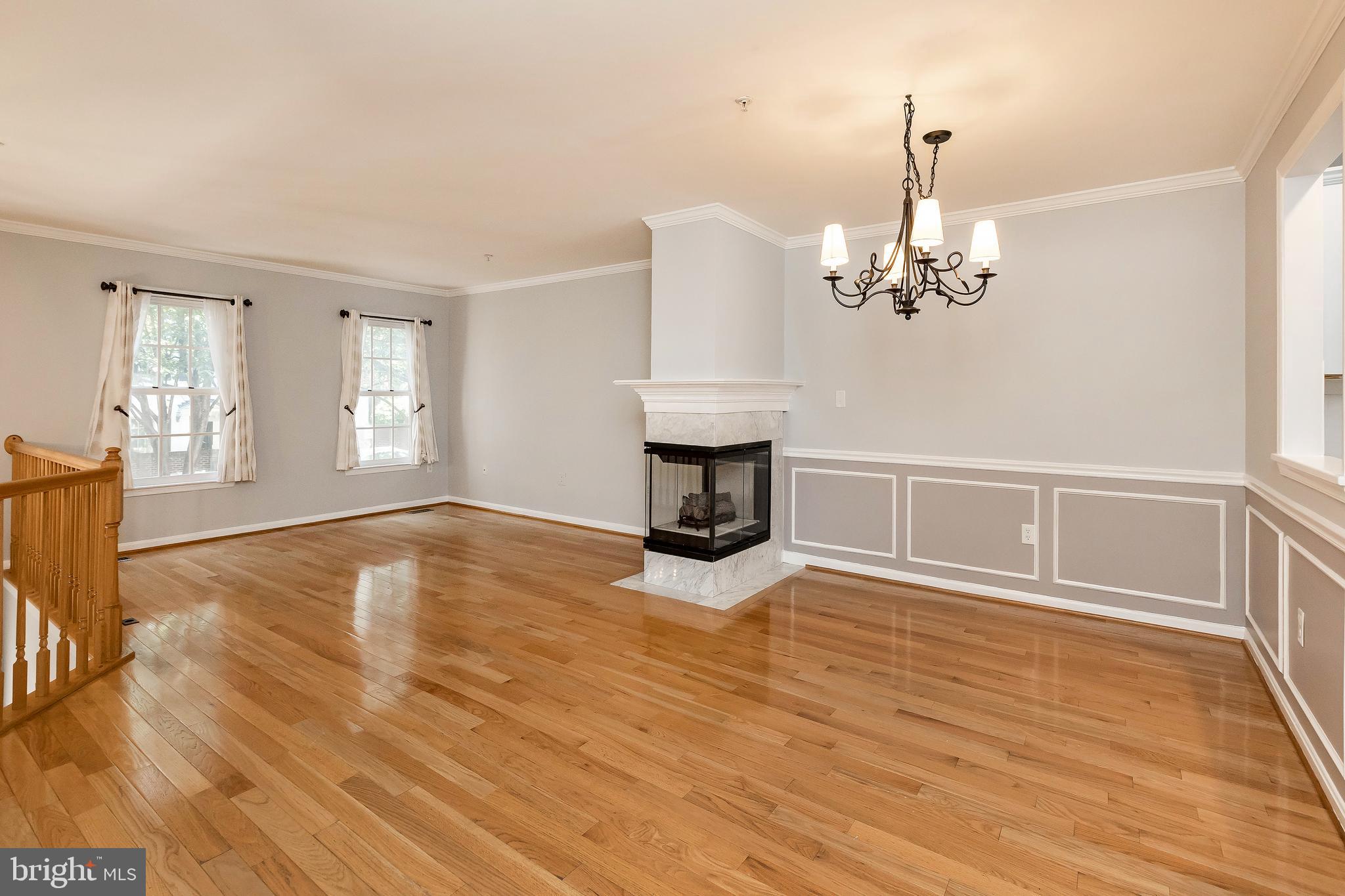 205 Ridgepoint Place Gaithersburg, MD 20878 - Photo 19 of 51 a view of an empty room with a window and wooden floor