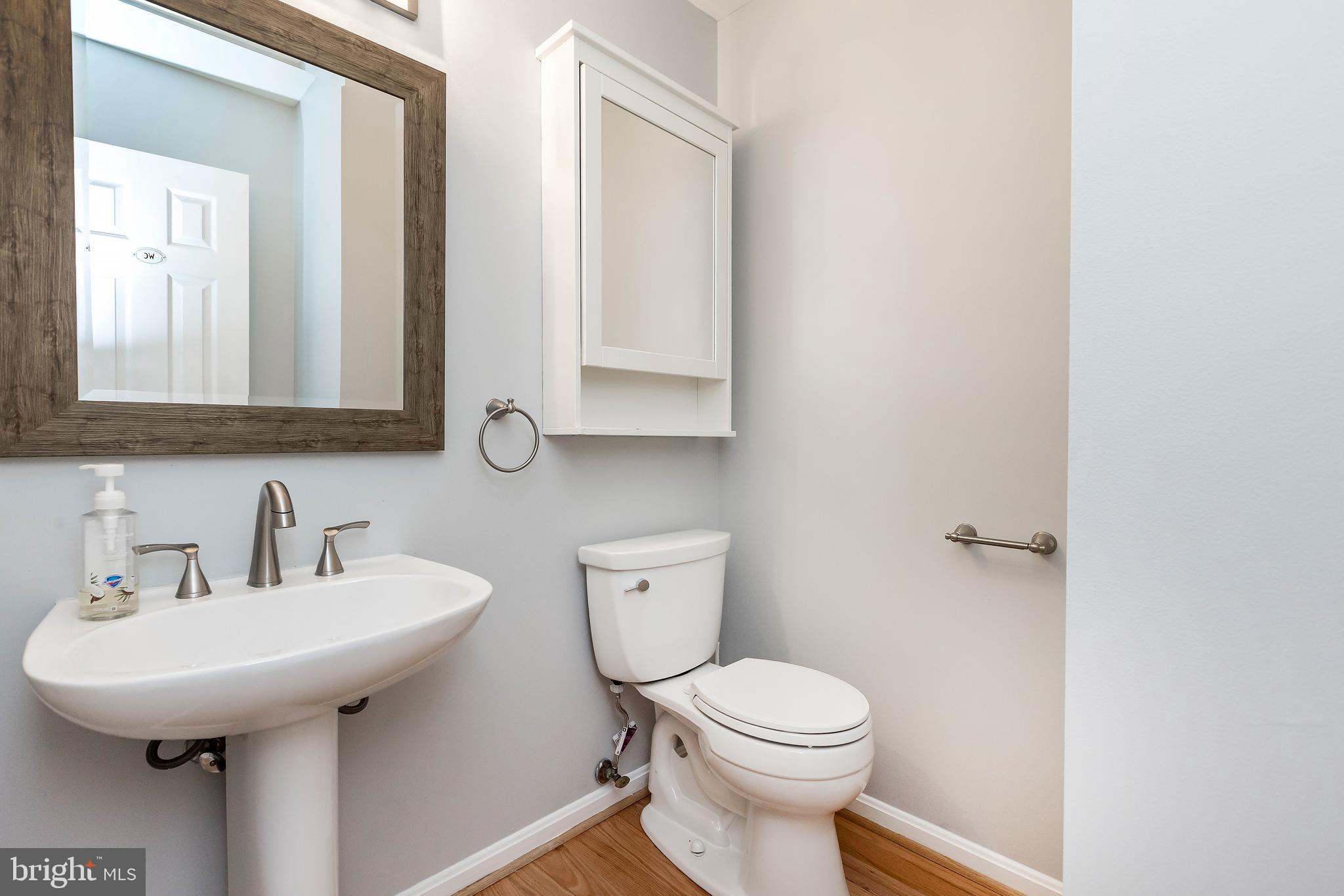 205 Ridgepoint Place Gaithersburg, MD 20878 - Photo 27 of 51 a bathroom with a toilet sink and mirror