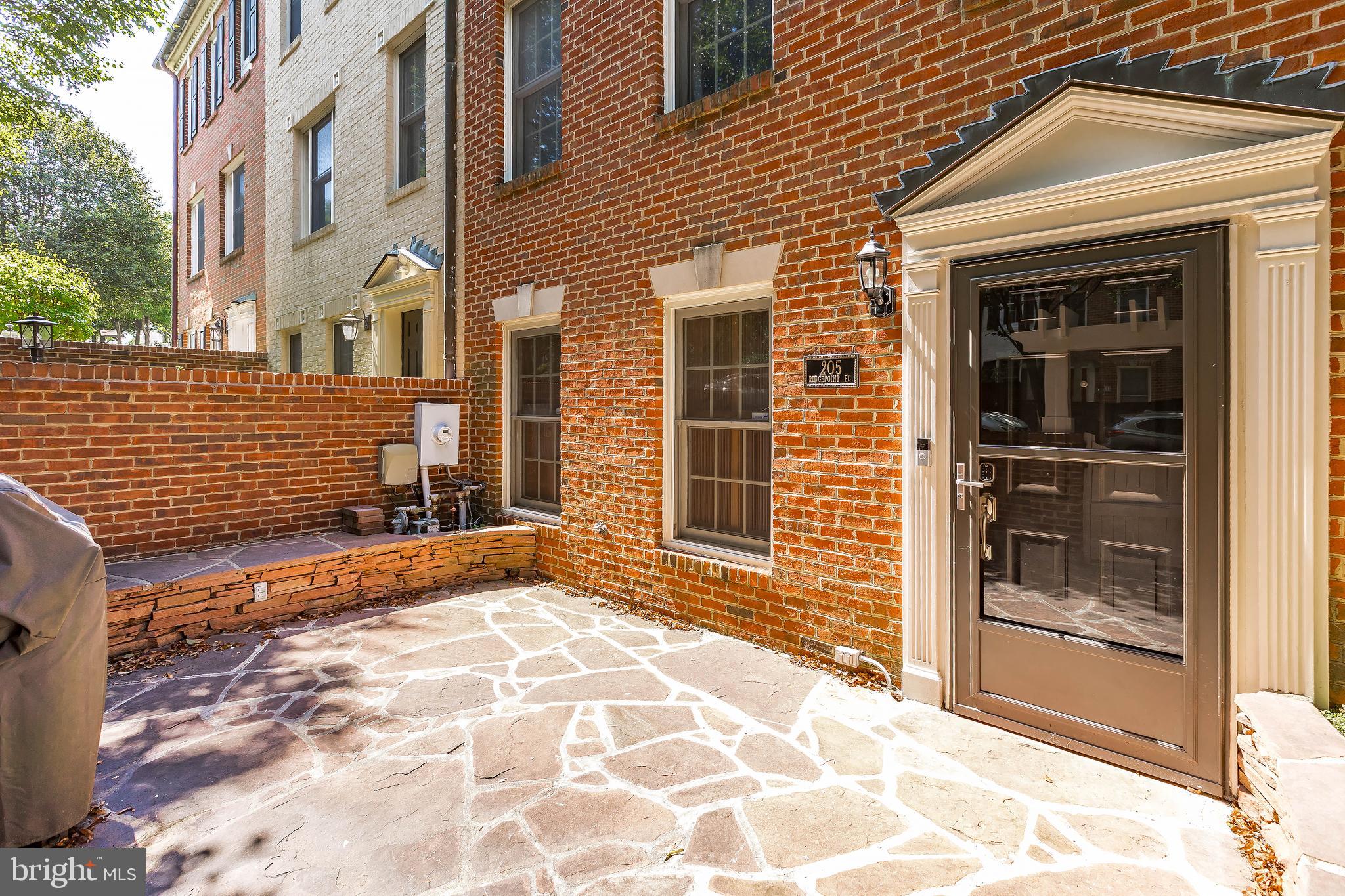 205 Ridgepoint Place Gaithersburg, MD 20878 - Photo 4 of 51 a view of a brick house with large windows