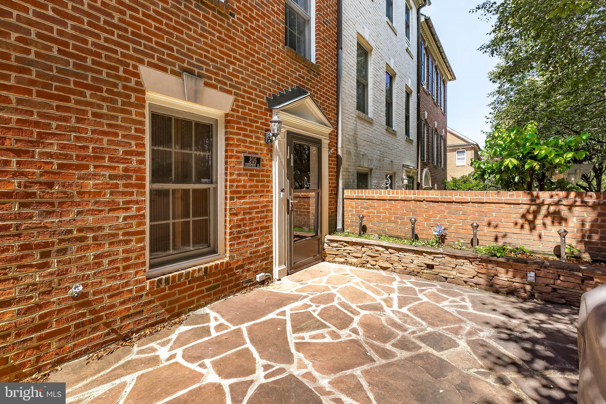 205 Ridgepoint Place Gaithersburg, MD 20878 - Photo 5 of 51 a view of a brick house with many windows