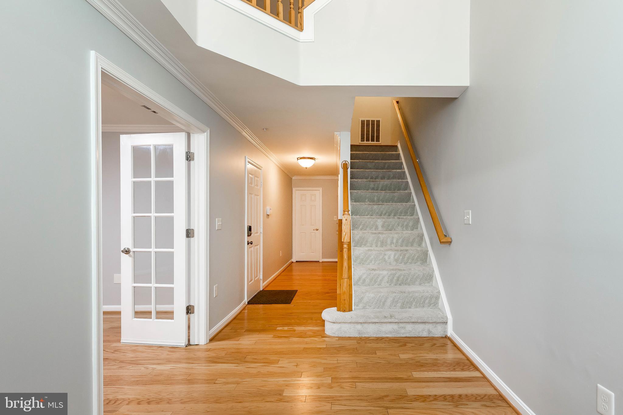 205 Ridgepoint Place Gaithersburg, MD 20878 - Photo 7 of 51 a view of a hallway with wooden floor and staircase