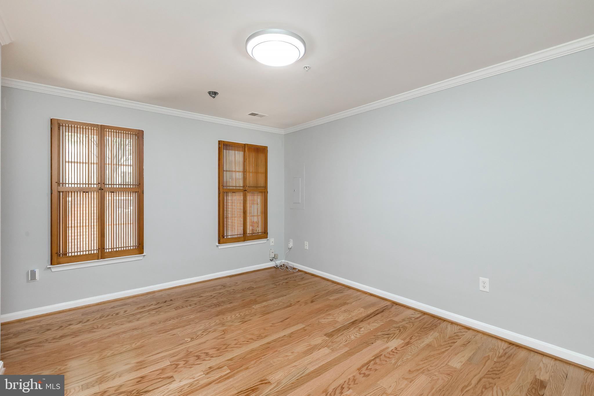 205 Ridgepoint Place Gaithersburg, MD 20878 - Photo 8 of 51 an empty room with wooden floor and windows
