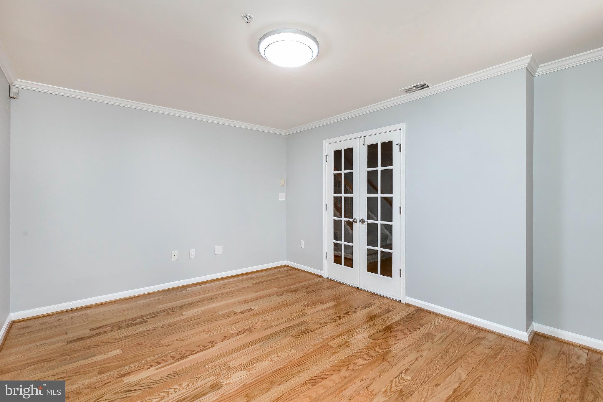 205 Ridgepoint Place Gaithersburg, MD 20878 - Photo 9 of 51 a view of empty room with wooden floor and fan