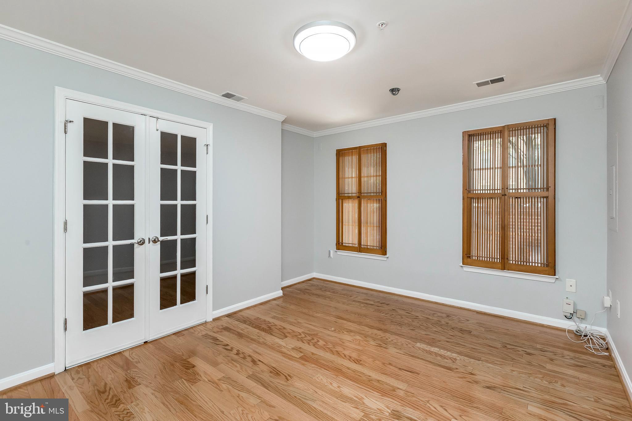 205 Ridgepoint Place Gaithersburg, MD 20878 - Photo 10 of 51 a view of an empty room with a window and wooden floor