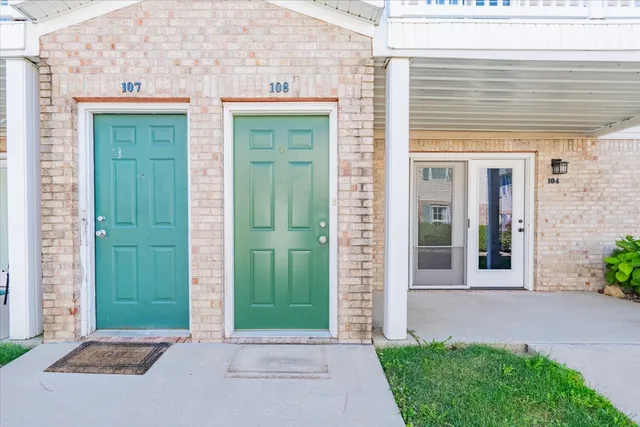 a view of a house with a small yard and a large window