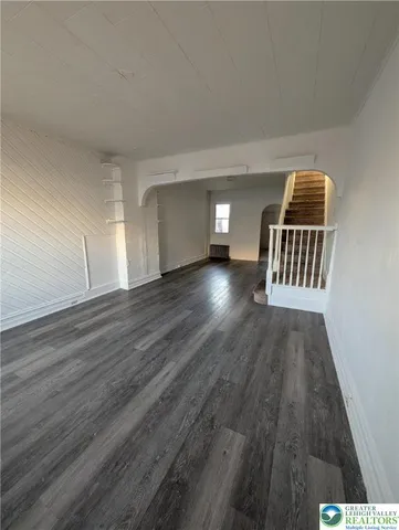 a view of a room with wooden floor and staircase