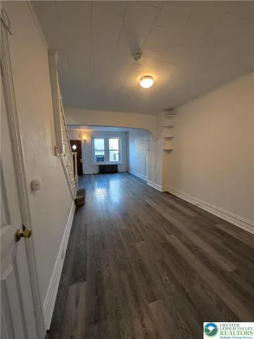 wooden floor in an empty room with a fireplace