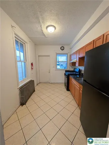 a kitchen with stainless steel appliances a refrigerator and a stove top oven
