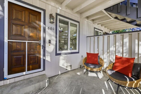 a outdoor view with a sitting space and glass windows