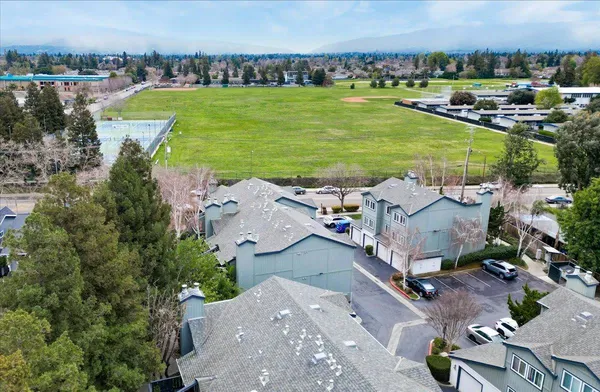 an aerial view of a house with a garden and pool