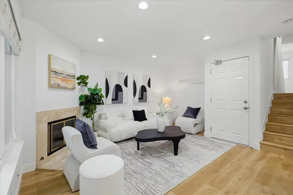 a living room with furniture and wooden floor