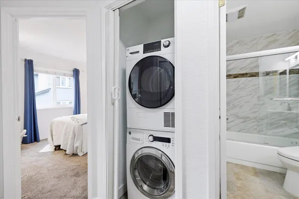 a view of a bedroom with washer and dryer