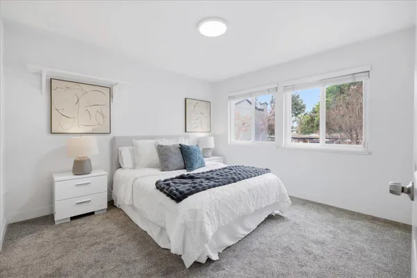 a bedroom with bed and window