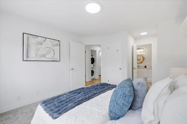 a bedroom with a large bed and a chandelier